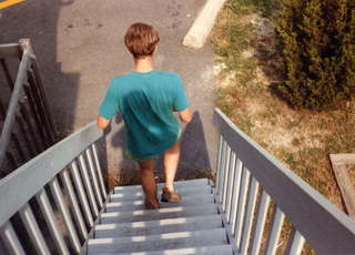 Tom Grey walking down stairs outside Design Computation