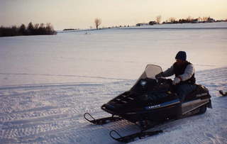 Adam riding snowmobile