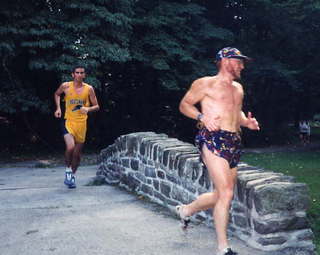 122 431. CHS XC, Adam running across bridge at two miles