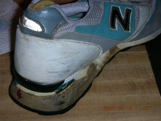 a very old running shoe falling apart