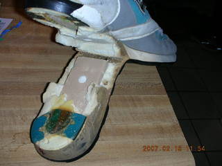 a very old running shoe falling apart