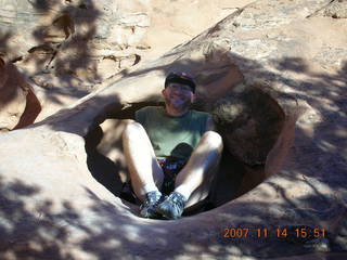 687 6be. Arches National Park - Devils Garden hike- Adam sitting in hole in rock