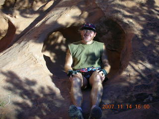 690 6be. Arches National Park - Devils Garden hike - Adam sitting in hole in rock