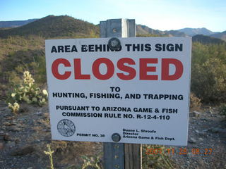 'Area behind this sign CLOSED to hunting, fishing, and trapping' sign.