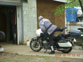 Dud getting on motorcycle