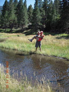 Dustin carrrying Adam across river - hiking at Pine Valley, Utah