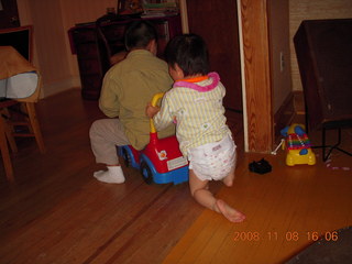 Gaby and Cecelia riding the toy truck