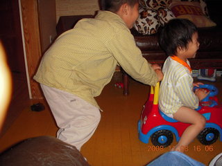 Gaby and Cecelia riding the toy truck