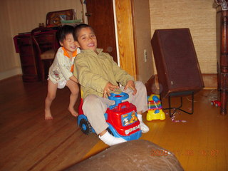 Cecelia and Gaby riding the toy truck