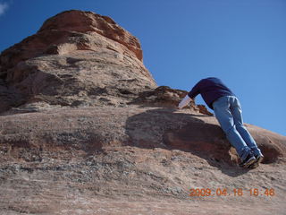 Arches National Park - hiker climbing near Delicate Arch