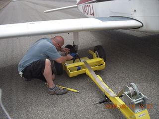 N4372J at Canyonlands (CNY) - flat tire - Gary affixing tow system