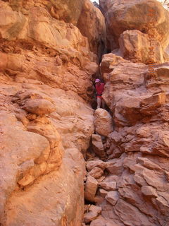 68 6uk. Arches National Park - Adam squeezing through Squeeze Through Arch - Fiery Furnace hike