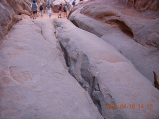 Arches National Park - Adam squeezing through Squeeze Through Arch - Fiery Furnace hike
