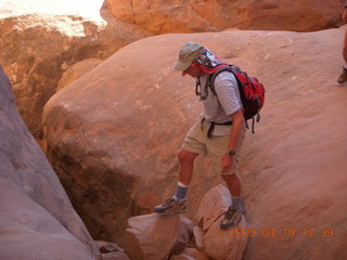 100 6uk. Arches National Park - Fiery Furnace hike - hiker crossing