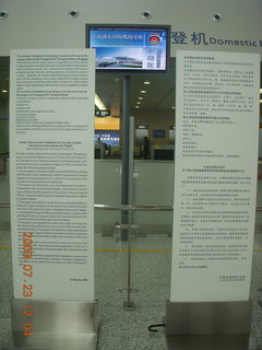 China eclipse - Shanghai airport sign with carry-on rules