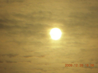 105 72s. sun in clouds seen though green visor