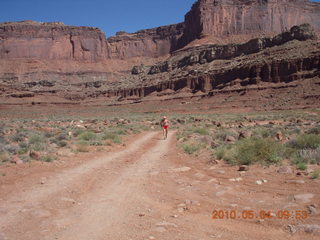 94 774. Canyonlands Lathrop Trail hike - Adam running on white rim road