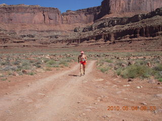 95 774. Canyonlands Lathrop Trail hike - Adam running on white rim road