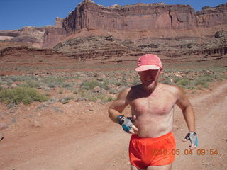 96 774. Canyonlands Lathrop Trail hike - Adam running on white rim road