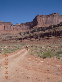 100 774. Canyonlands Lathrop Trail hike - Adam running on white rim road