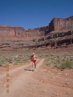 101 774. Canyonlands Lathrop Trail hike - Adam running on white rim road