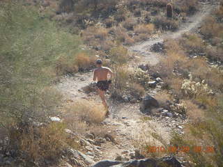 Canyonlands Lathrop Trail hike - Adam running on white rim road - back