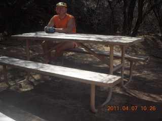 23 7j7. Canyonlands Lathrop hike/run - Adam at riverside picnic table at (tripod)