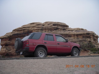 284 7j8. Canyonlands Needles Slickrock hike - Rodeo and rock seen from below - looks tough