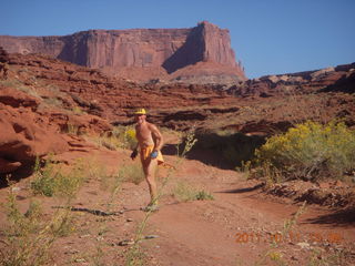 Canyonlands National Park - Lathrop trail hike - Adam running, turning around (tripod)