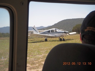 851 7xc. aerial - 'Young International' airstrip (AZ24) - N8377W through window of vehicle