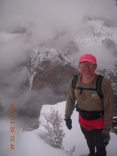 130 84q. Zion National Park - cloudy, foggy Observation Point hike - Adam at the top