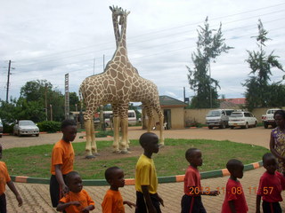 Uganda - Entebbe - Uganda Wildlife Education Center (UWEC) - school children and giraffe sculpture