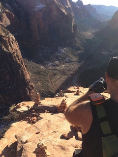 Zion National Park - Angels Landing hike - Brian leaning over taking a picture at the top