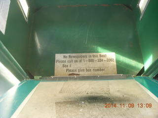 Metro newspaper dispenser with no newspapers but with a phone number