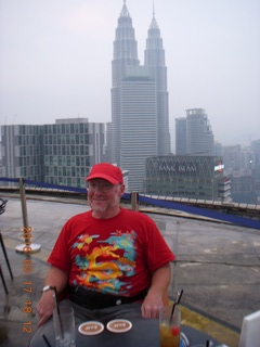 Malaysia - Kuala Lumpur - Heli Lounge Bar - Adam sitting - twin Petronas towers