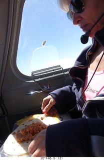 85 9sk. Kim eating her in-flight meal