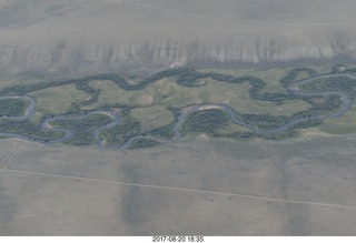 115 9sl. aerial - Riverton to Rock Springs - winding river in wide wash