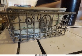 two dollar bill in the pizza place tip basket