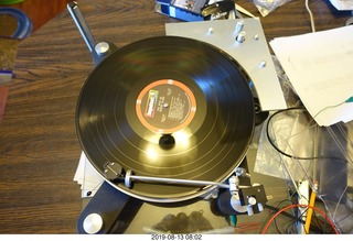 Trasncriptor Skeleton turntable and Vestigal tonearm playing a record