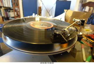 Trasncriptor Skeleton turntable and Vestigal tonearm playing a record