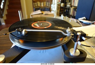 Trasncriptor Skeleton turntable and Vestigal tonearm playing a record