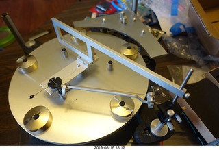 Trasncriptor Skeleton turntable and Vestigal tonearm playing a record