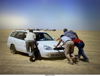 pushing a car in the soft sand