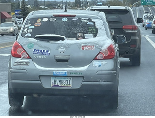 182 a18. drive on Route 89 to Flagstaff - snow and stickers on a car