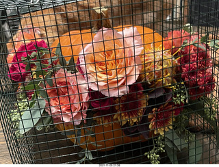 pumpkin flower arrangement in a cage