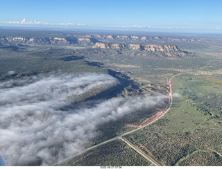 aerial - flight to Mystic Bluffs - fog in the valleys