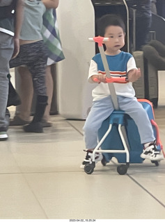 11 a1s. kid with cool riding toy from a suitcase