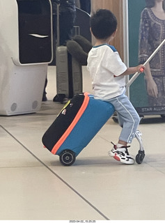12 a1s. kid with cool riding toy from a suitcase