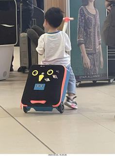 13 a1s. kid with cool riding toy from a suitcase