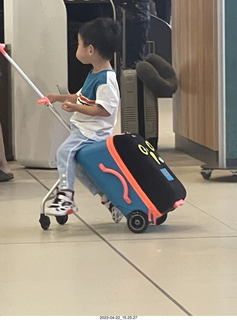 14 a1s. kid with cool riding toy from a suitcase